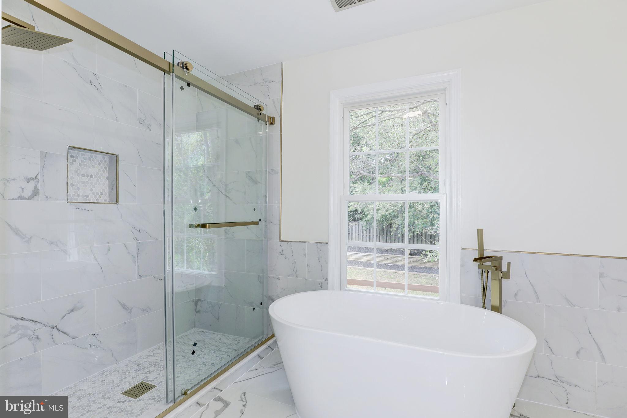 14422 Old Stage Road Bowie, MD 20720 - Photo 32 of 65 a bathroom with a bathtub and shower