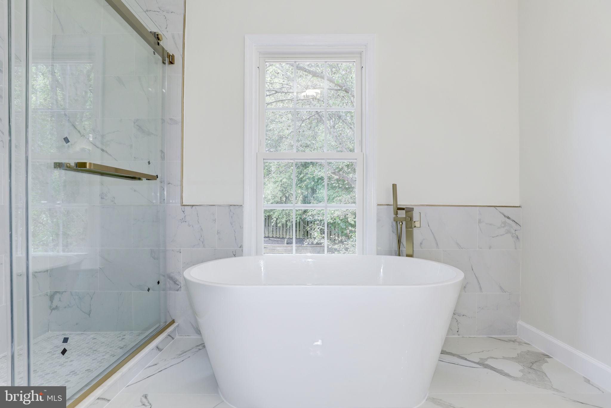 14422 Old Stage Road Bowie, MD 20720 - Photo 33 of 65 a white bath tub sitting in a bathroom next to a window