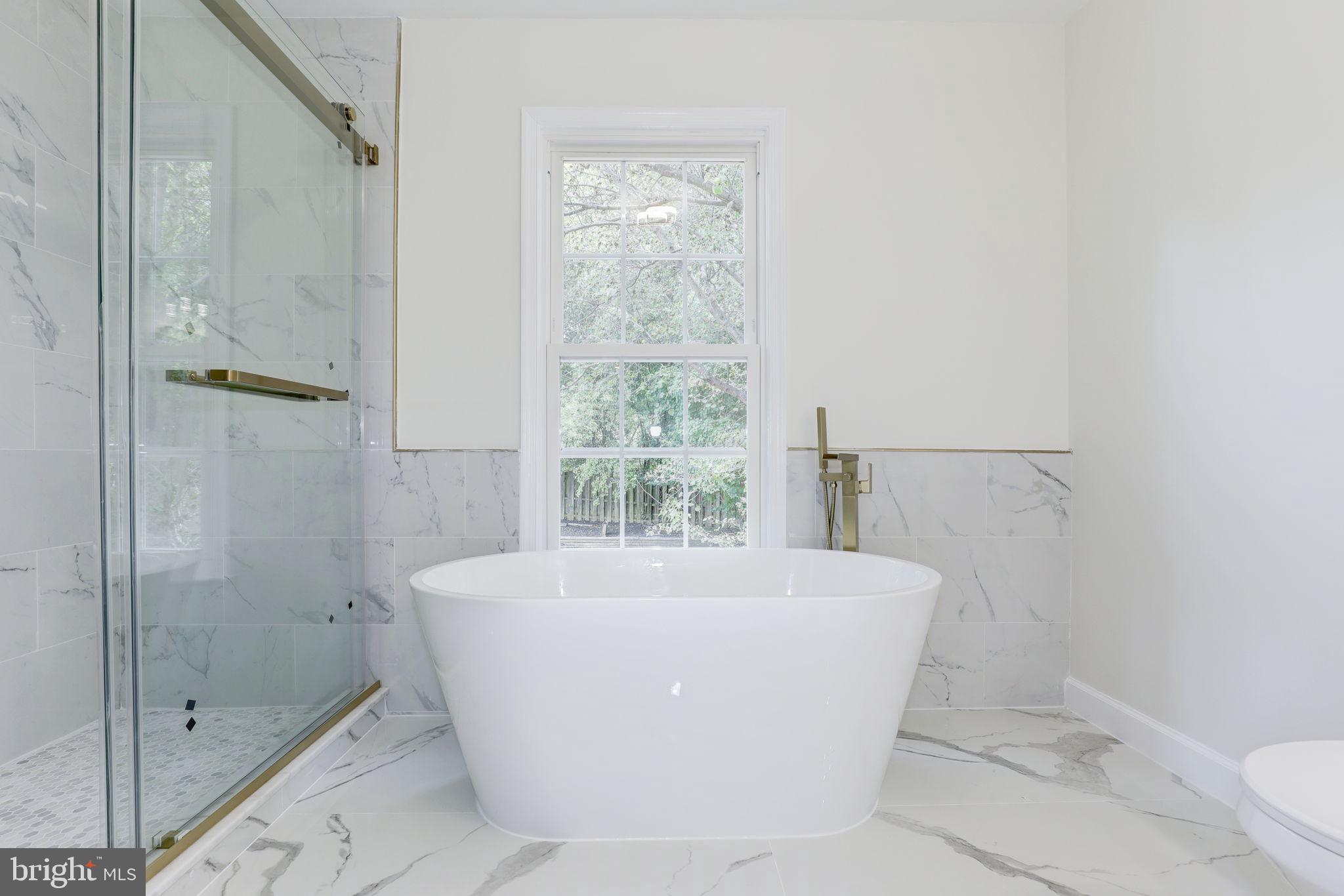 14422 Old Stage Road Bowie, MD 20720 - Photo 34 of 65 a white bath tub sitting next to a toilet