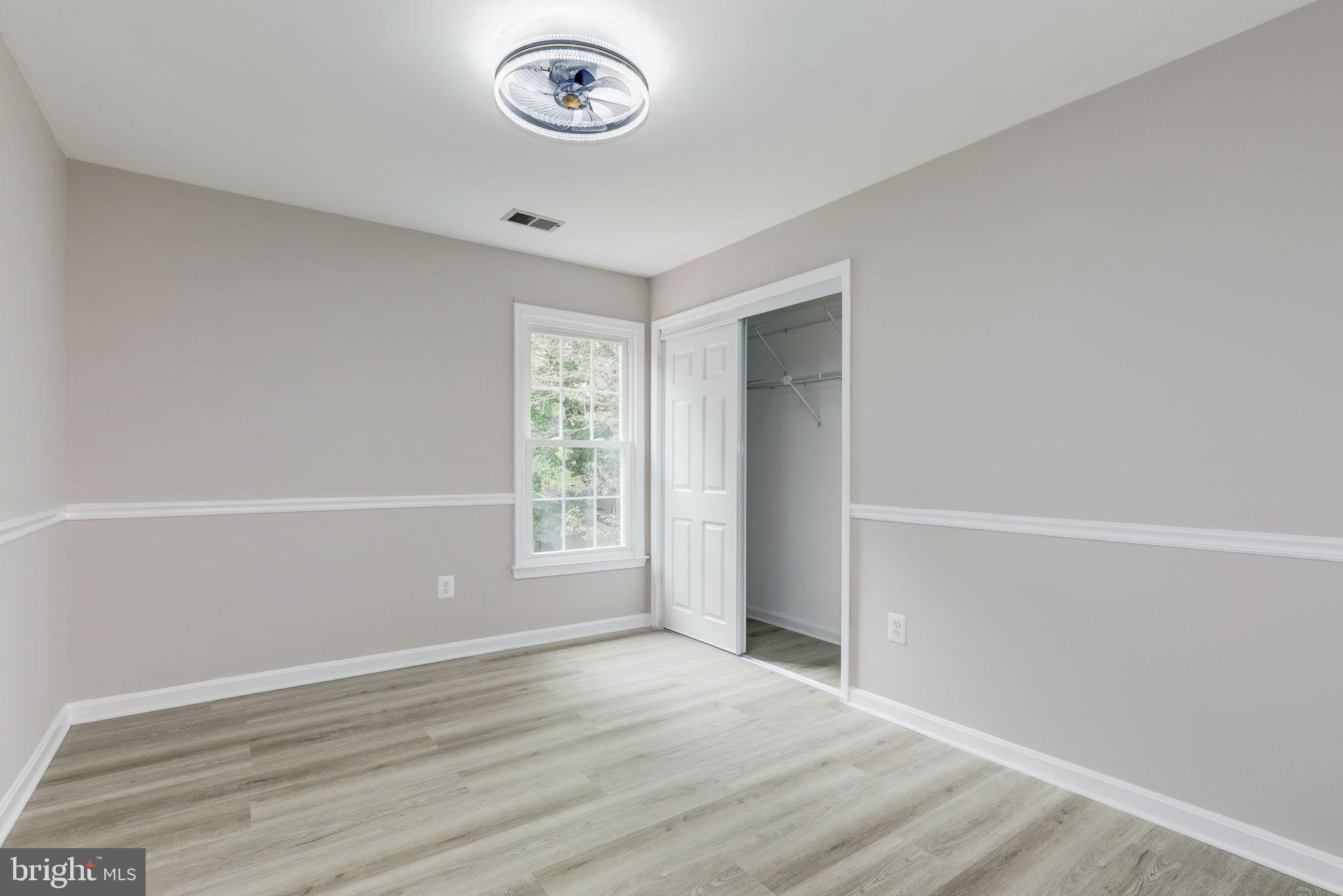 14422 Old Stage Road Bowie, MD 20720 - Photo 35 of 65 an empty room with wooden floor and windows