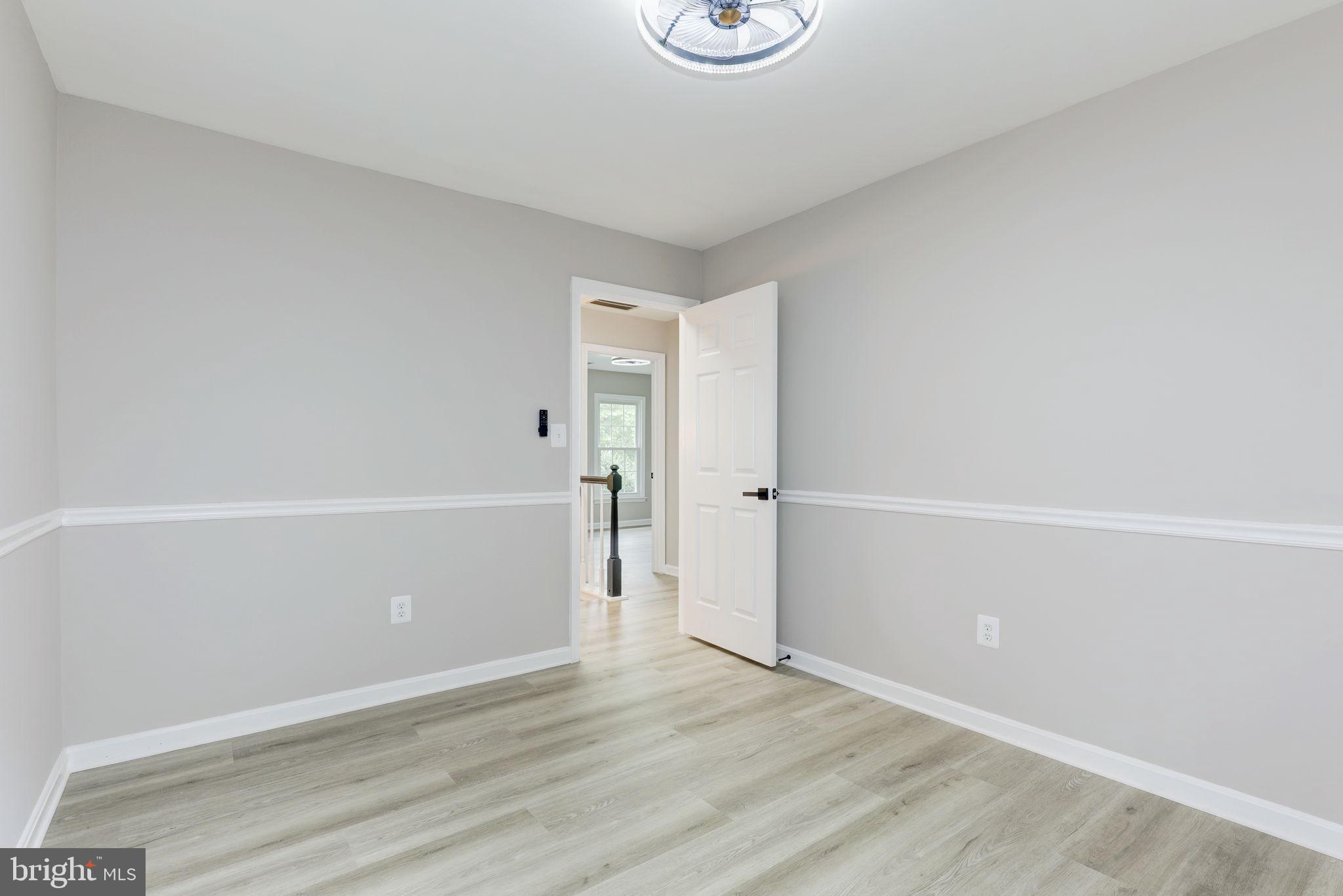 14422 Old Stage Road Bowie, MD 20720 - Photo 38 of 65 an empty room with wooden floor and white walls