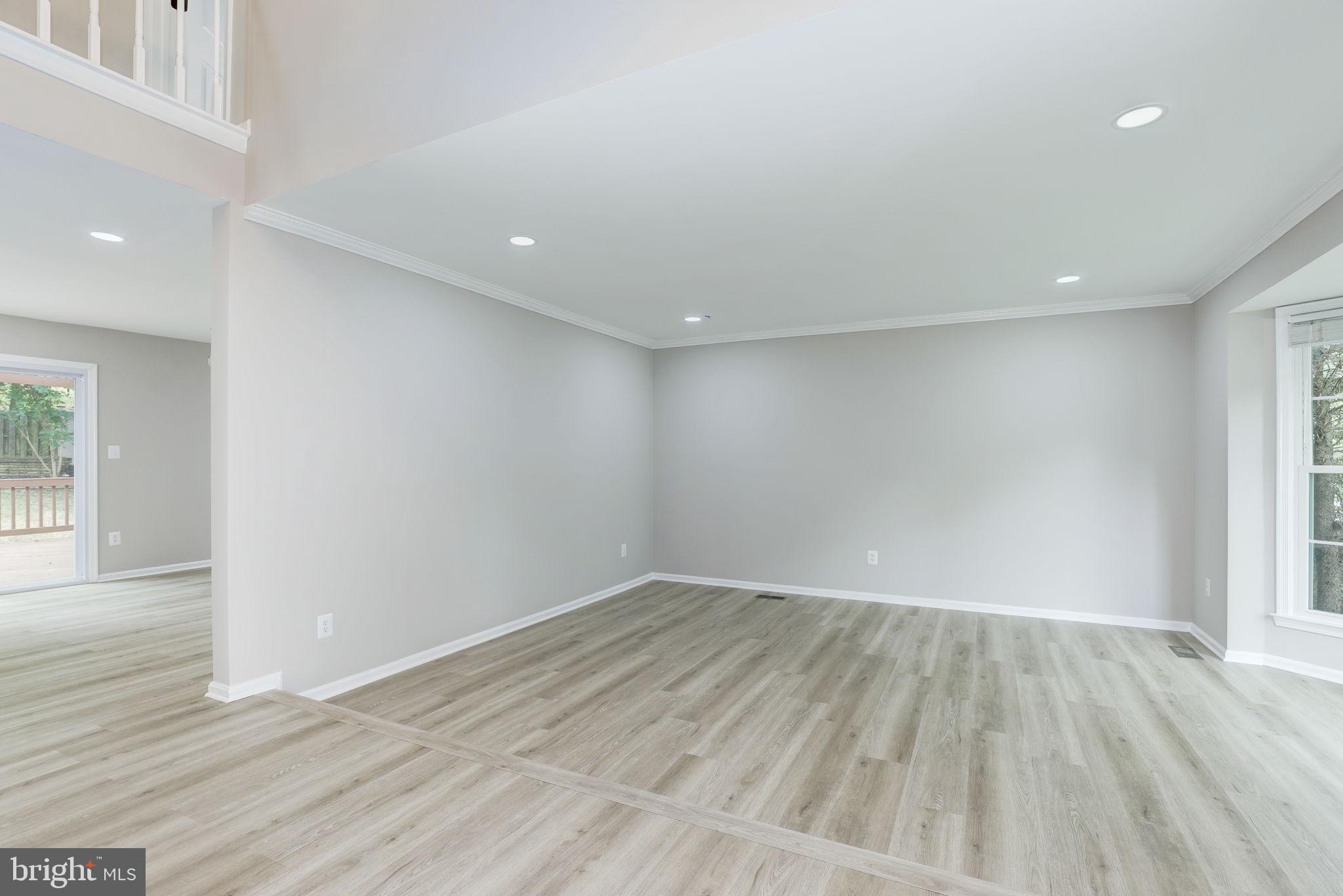 14422 Old Stage Road Bowie, MD 20720 - Photo 4 of 65 an empty room with wooden floor and windows