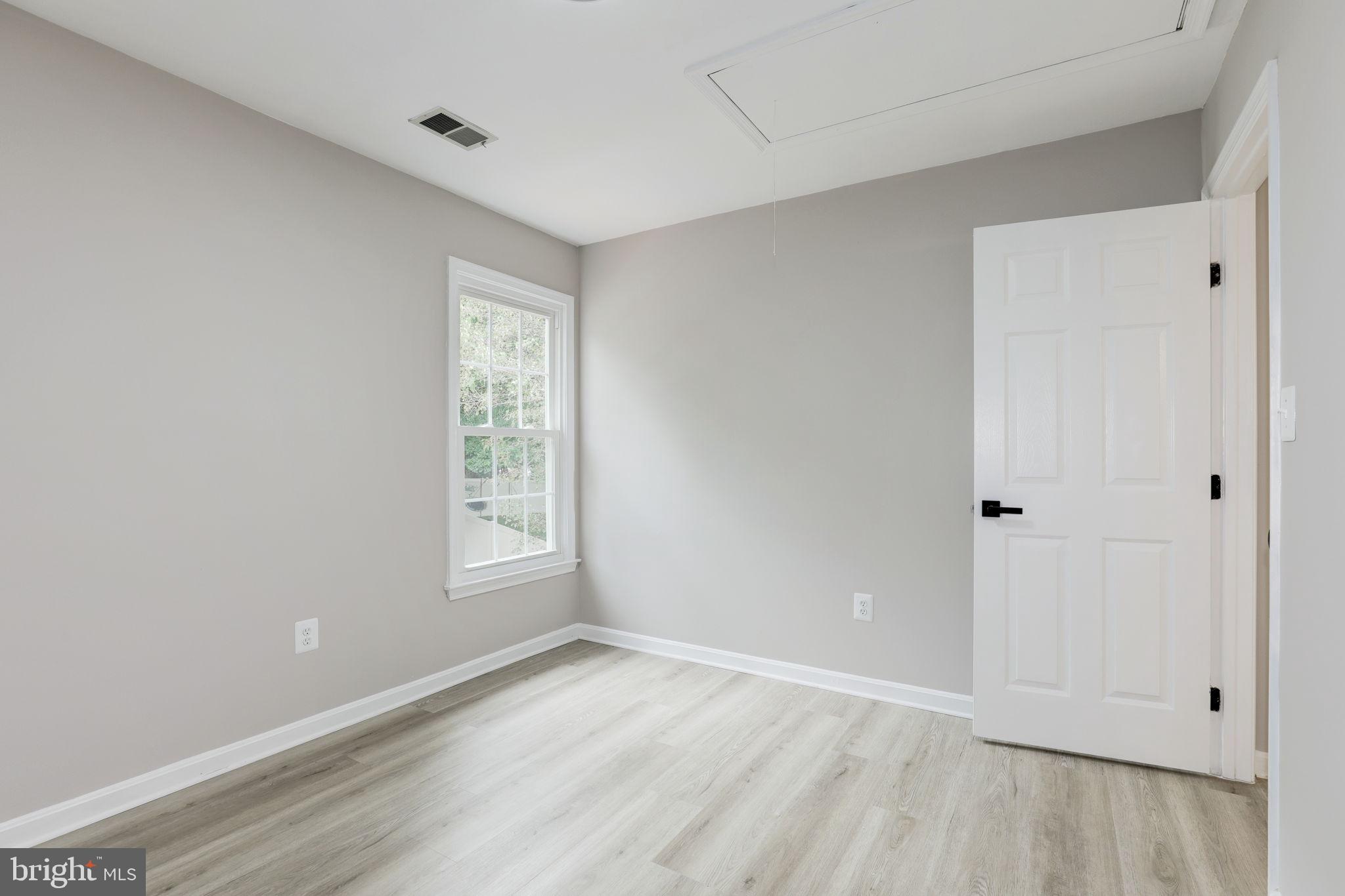 14422 Old Stage Road Bowie, MD 20720 - Photo 41 of 65 a view of an empty room with wooden floor and a window