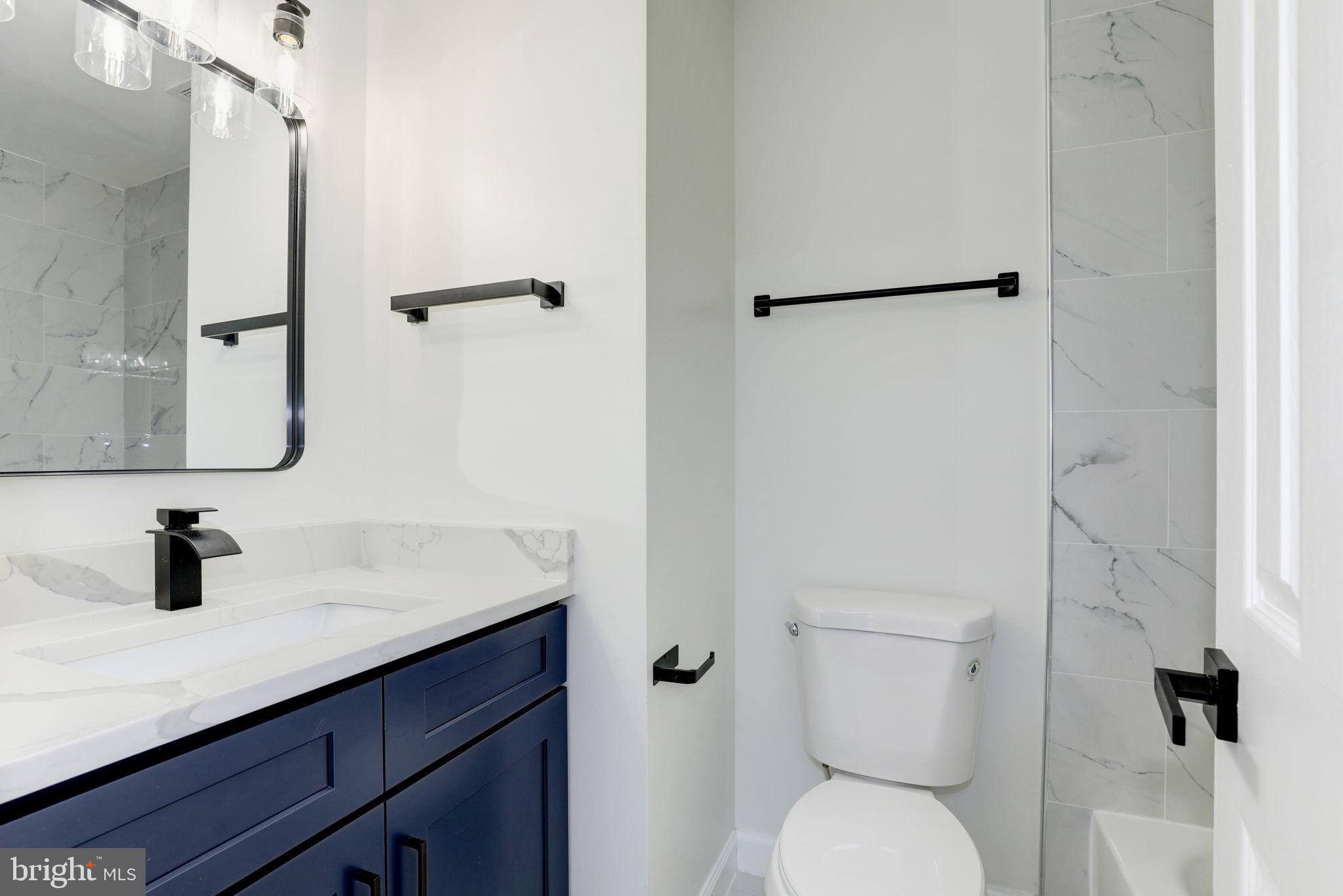 14422 Old Stage Road Bowie, MD 20720 - Photo 42 of 65 a bathroom with a sink toilet and shower