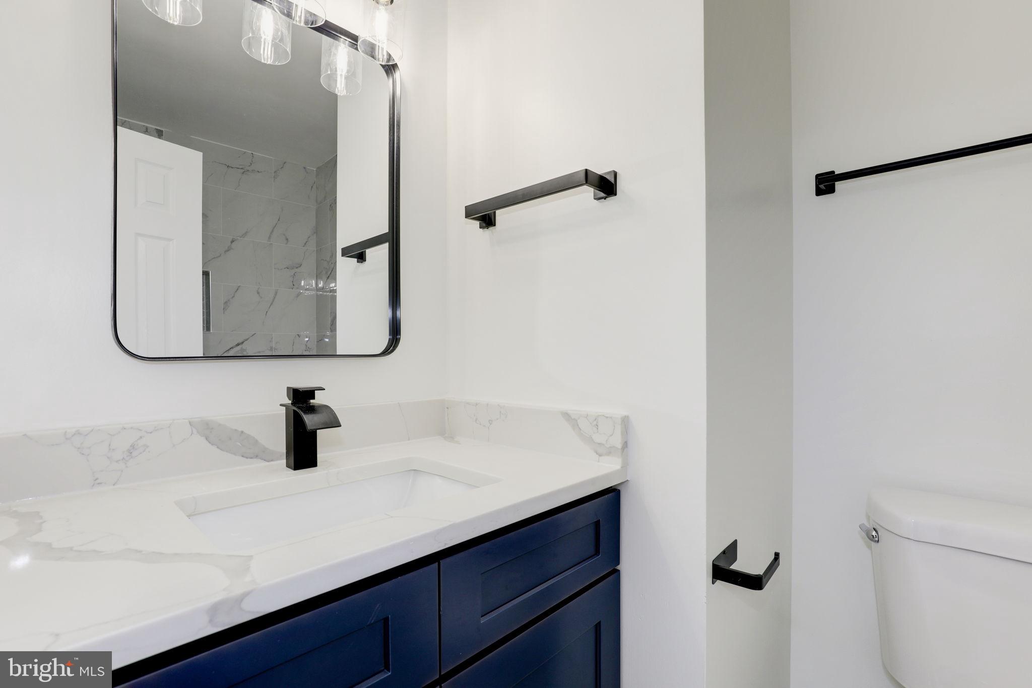 14422 Old Stage Road Bowie, MD 20720 - Photo 44 of 65 a bathroom with a sink and mirror