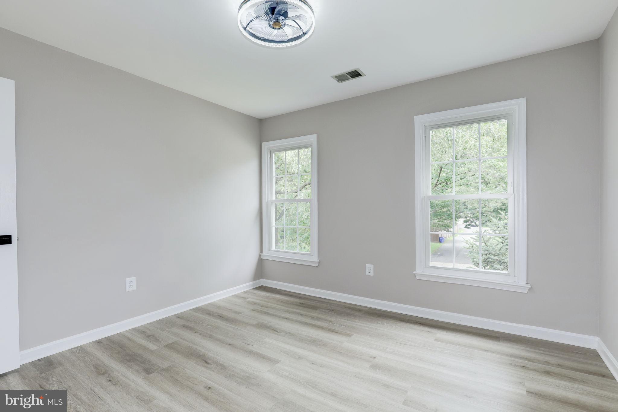 14422 Old Stage Road Bowie, MD 20720 - Photo 46 of 65 a view of an empty room with wooden floor and window