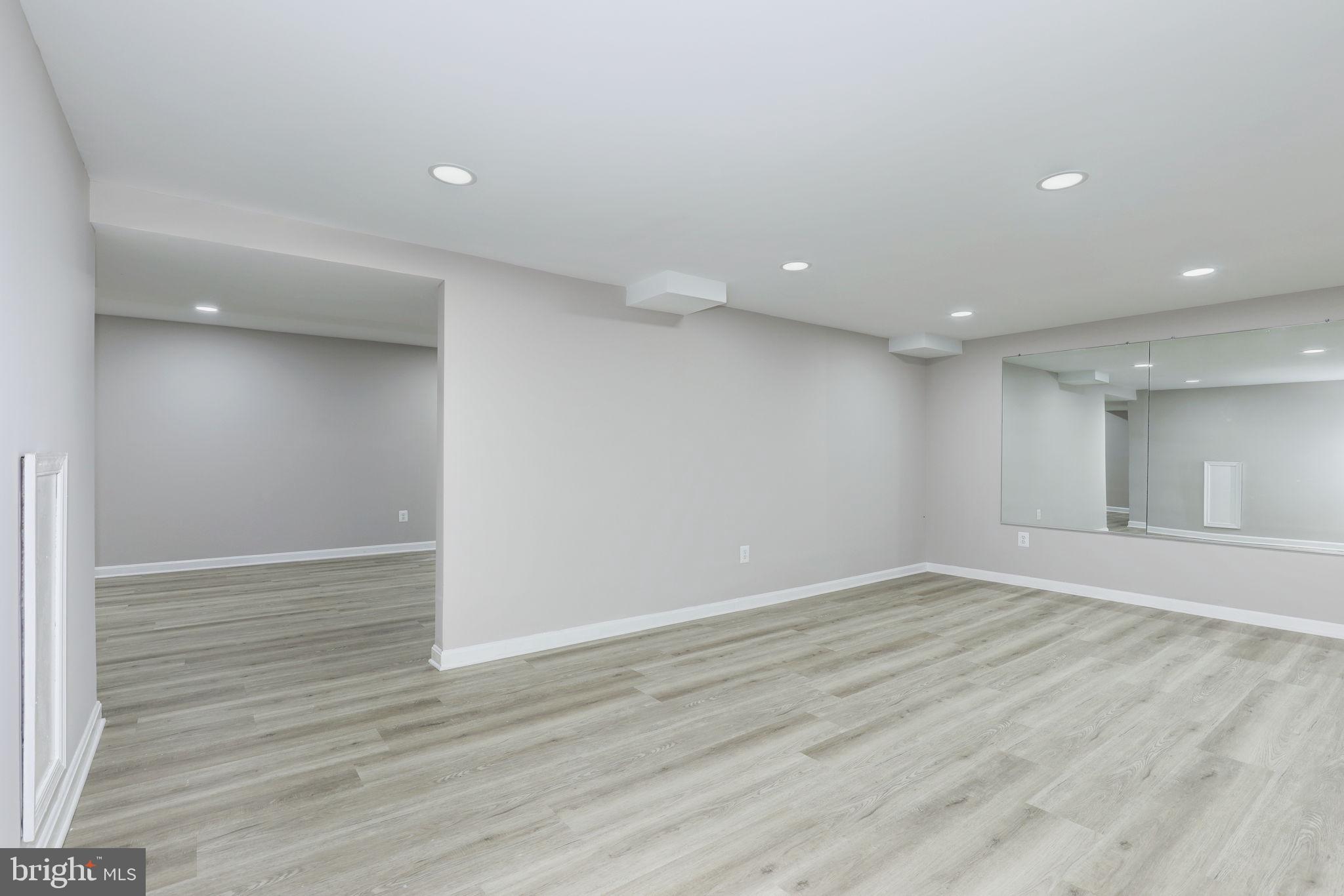 14422 Old Stage Road Bowie, MD 20720 - Photo 49 of 65 an empty room with wooden floor and windows