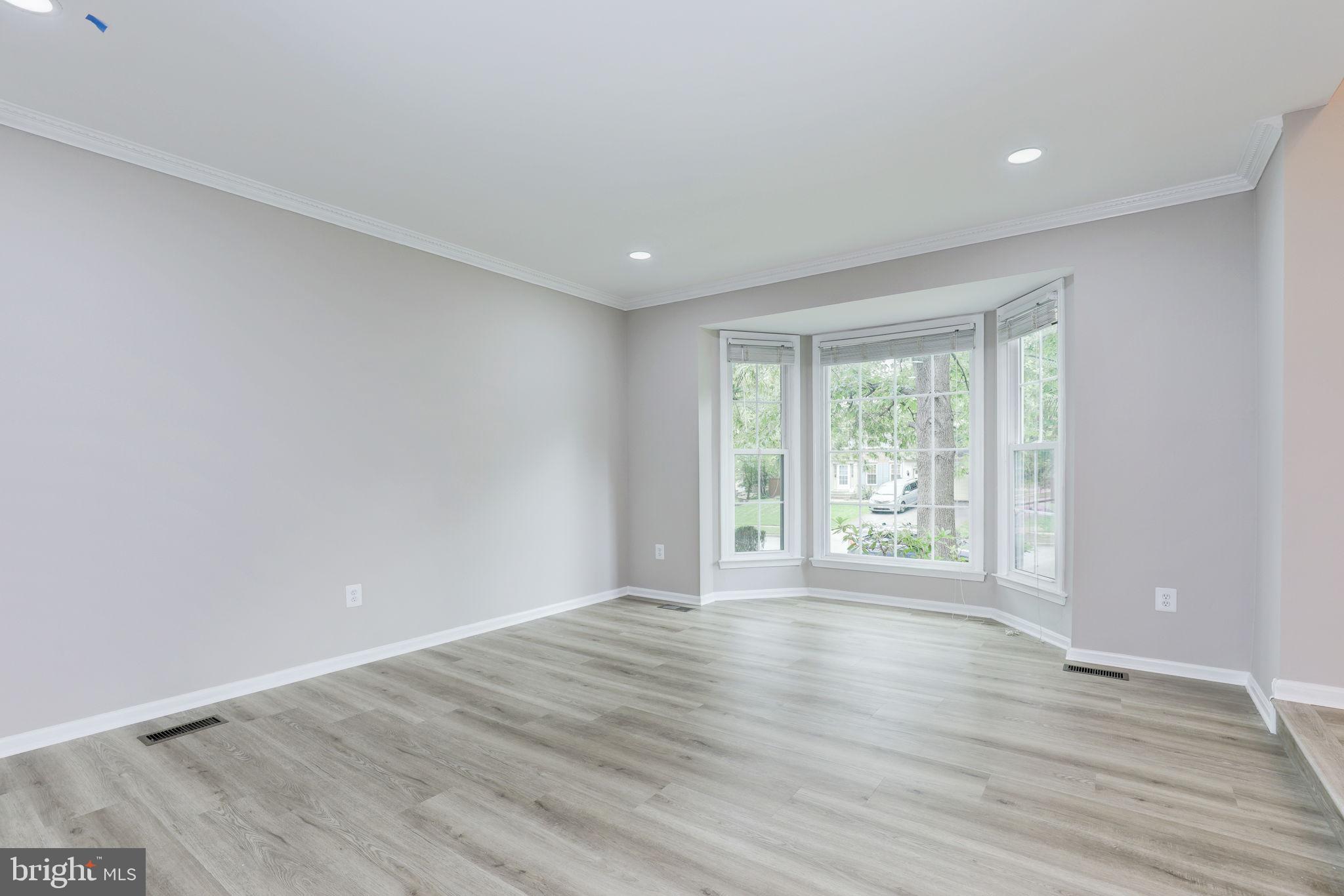 14422 Old Stage Road Bowie, MD 20720 - Photo 5 of 65 a view of an empty room with wooden floor and a window