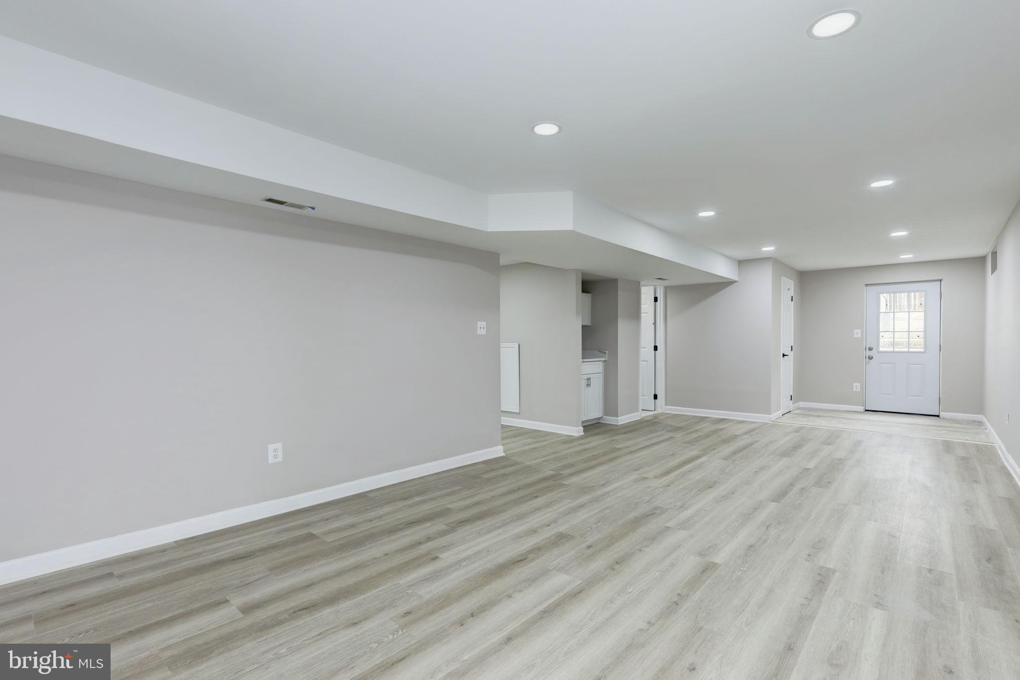 14422 Old Stage Road Bowie, MD 20720 - Photo 55 of 65 a view of an empty room with window and wooden floor