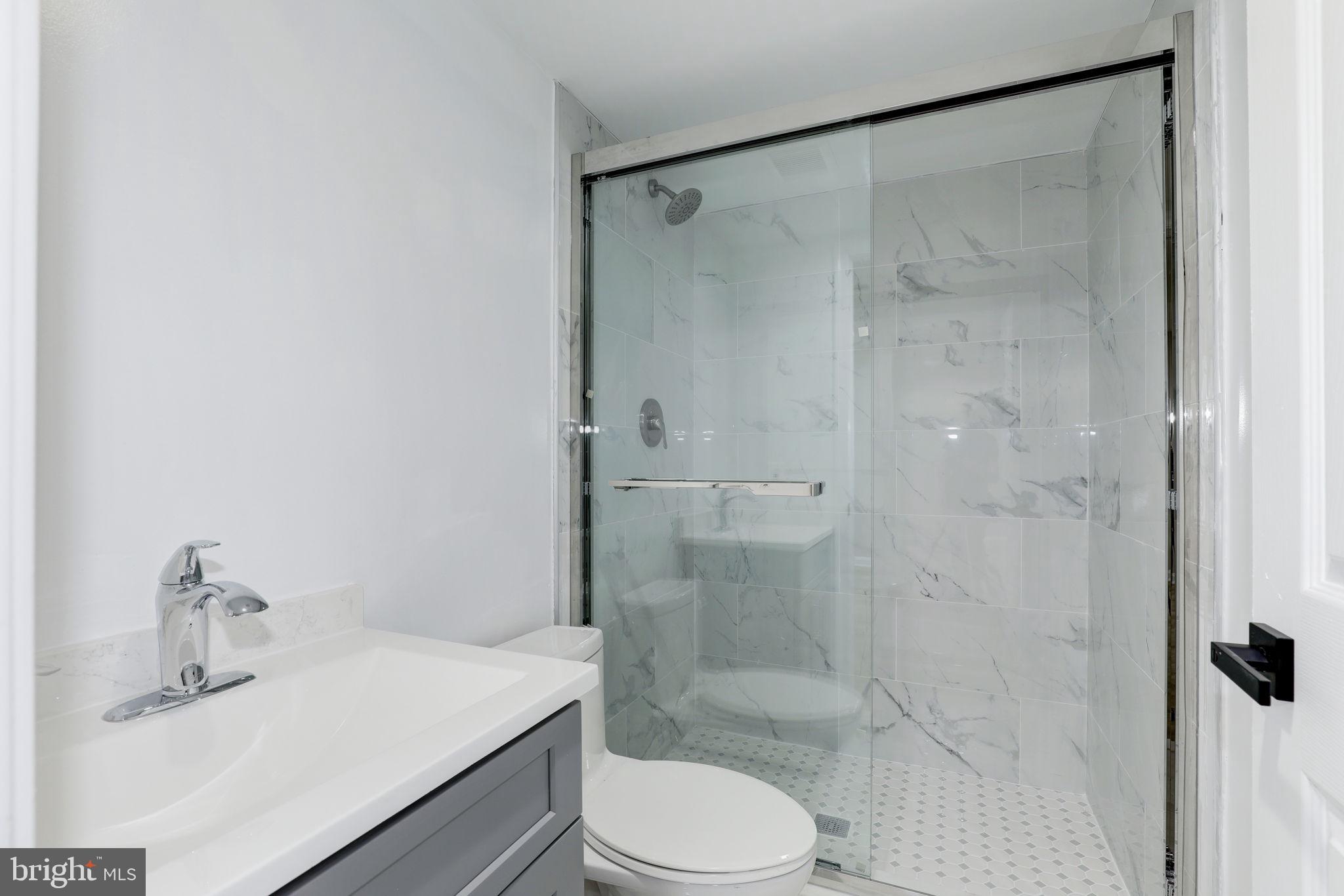 14422 Old Stage Road Bowie, MD 20720 - Photo 57 of 65 a bathroom with a sink toilet and shower