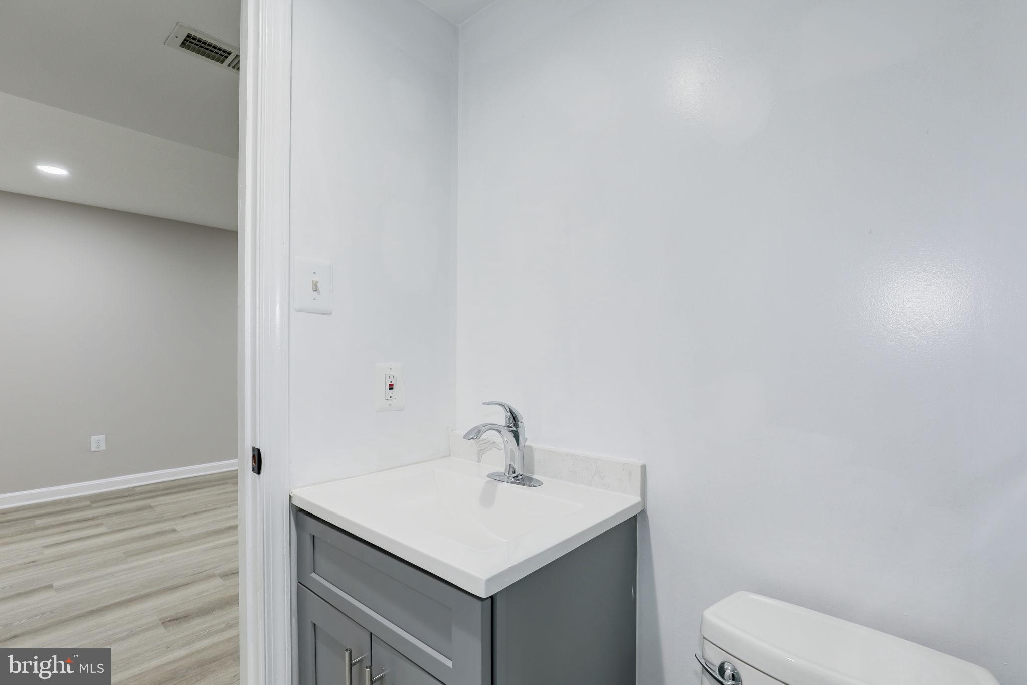 14422 Old Stage Road Bowie, MD 20720 - Photo 58 of 65 a bathroom with a sink toilet and vanity