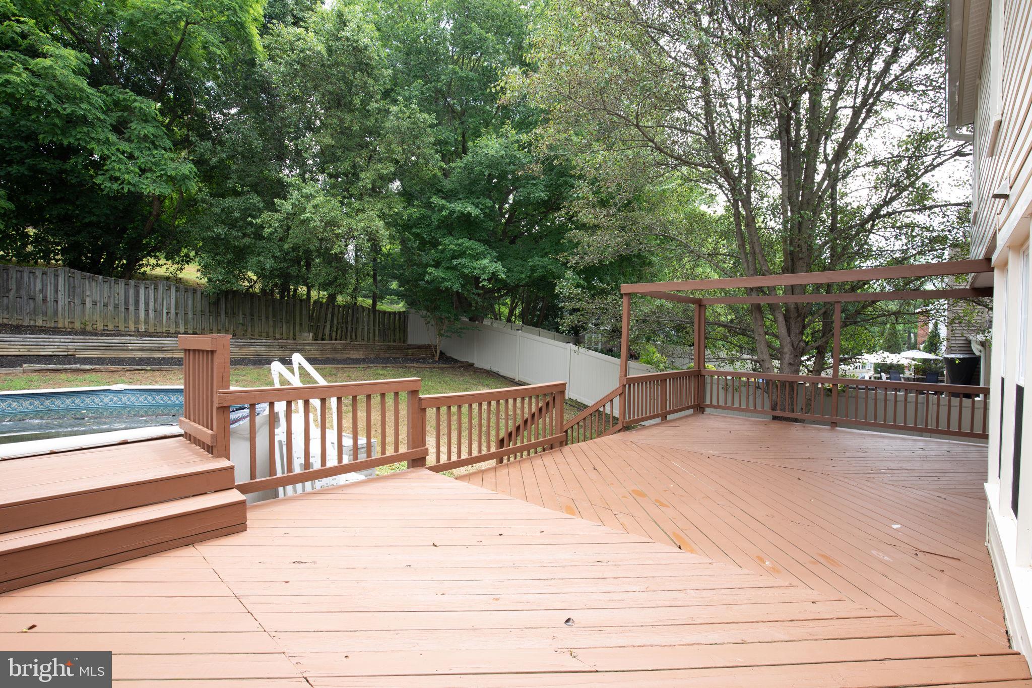 14422 Old Stage Road Bowie, MD 20720 - Photo 64 of 65 a patio with table and chairs and wooden floor