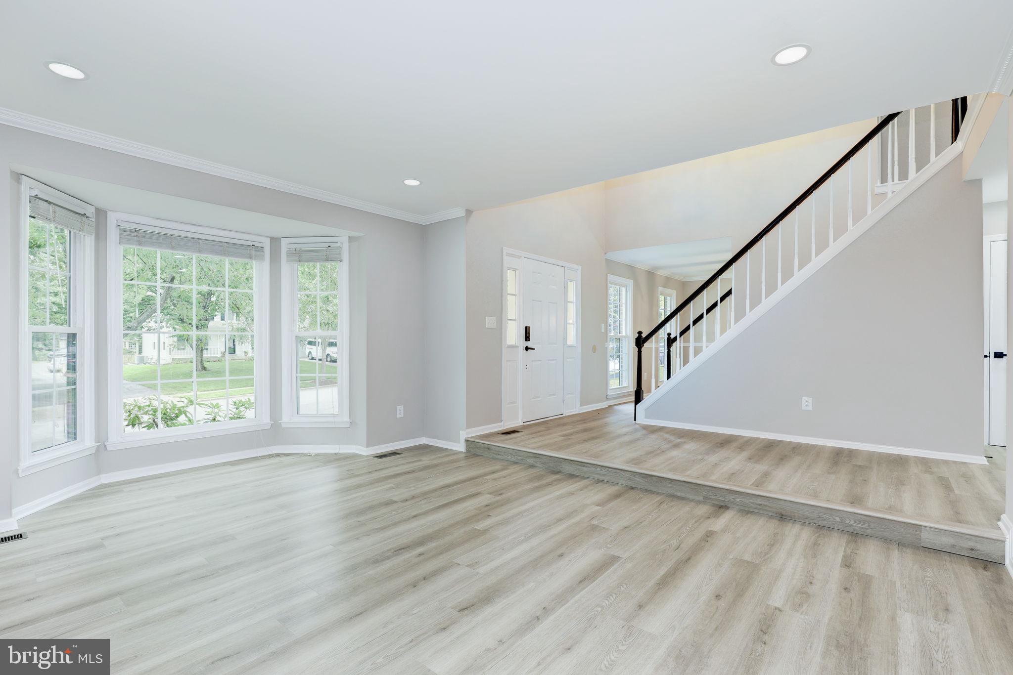 14422 Old Stage Road Bowie, MD 20720 - Photo 7 of 65 a view of an empty room with wooden floor and fan