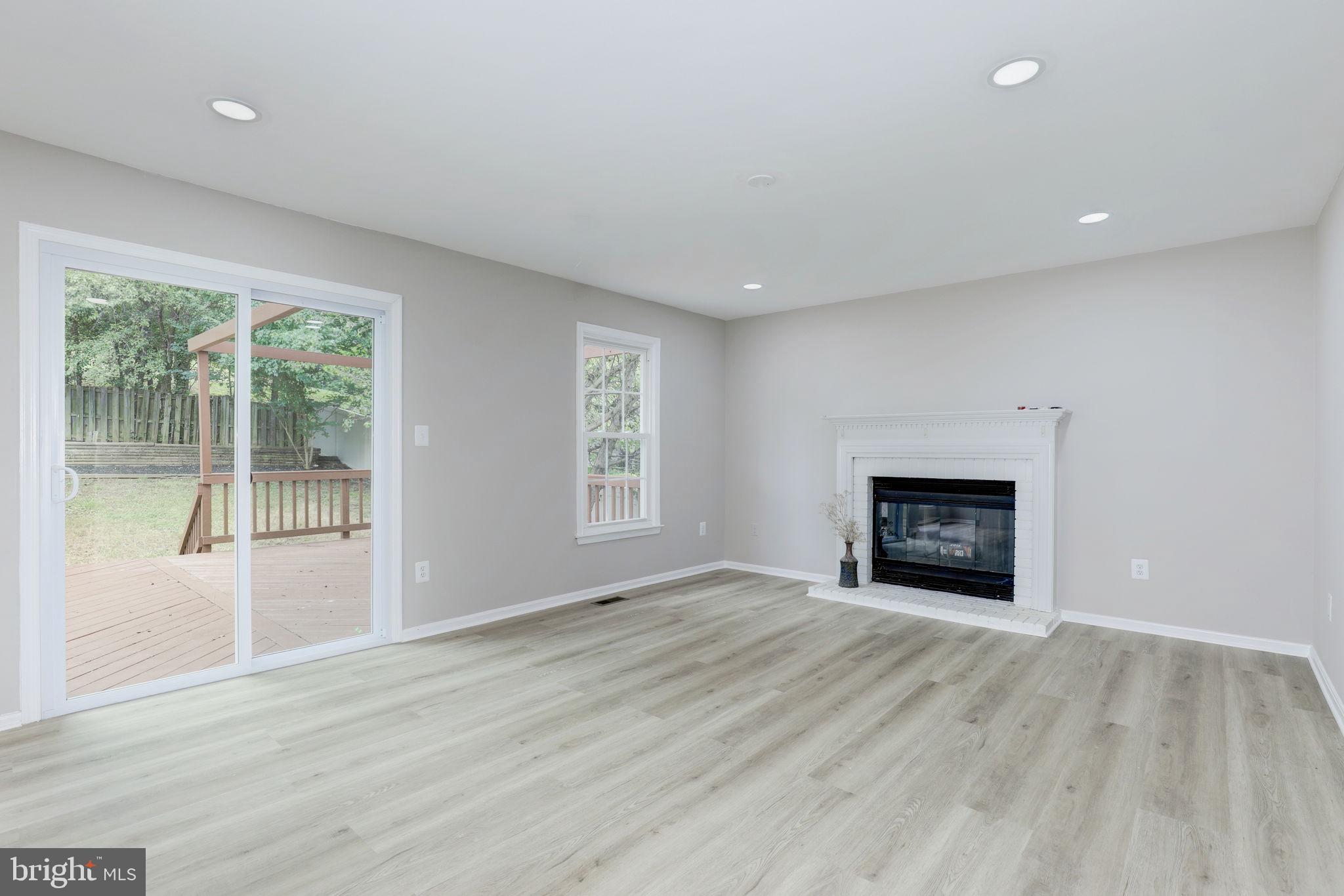14422 Old Stage Road Bowie, MD 20720 - Photo 8 of 65 a view of an empty room with wooden floor and a window