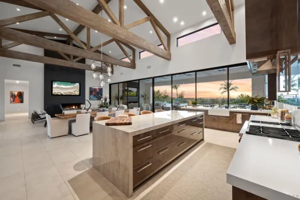 a view of living room with kitchen island furniture and a large window