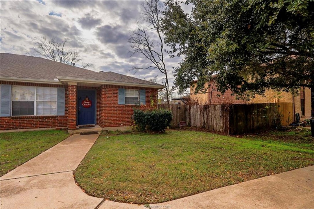 1802 Treehouse Trail, Unit A College Station, TX 77845 - Photo 1 of 13 a view of a house with backyard and tree