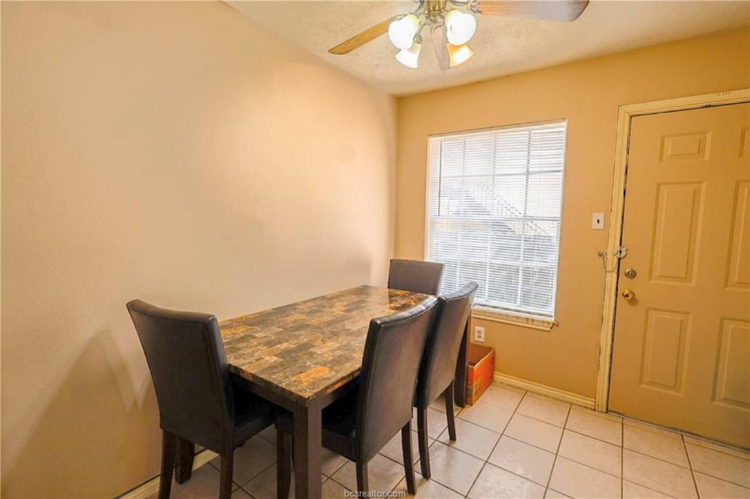 1802 Treehouse Trail, Unit A College Station, TX 77845 - Photo 7 of 13 a view of a dining room with furniture and chandelier