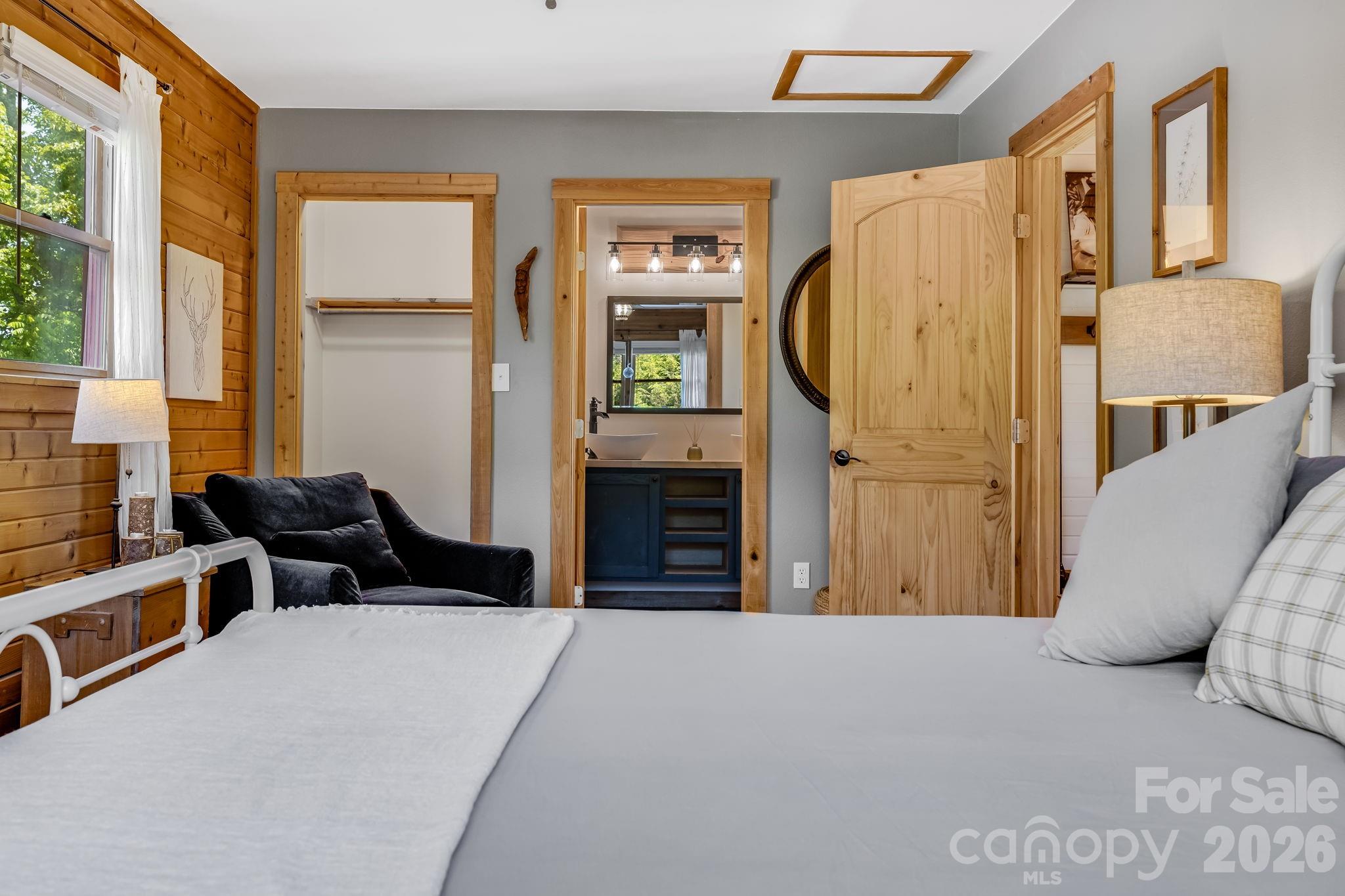 694 Boulder Road Marshall, NC 28753 - Photo 27 of 44 a bedroom with a bed and a window