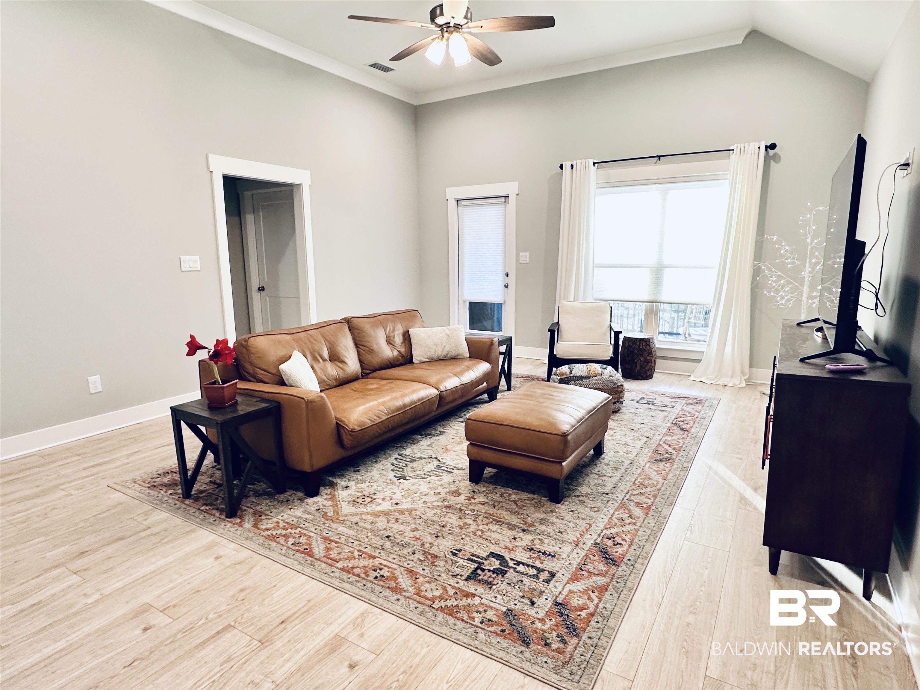 655 H Norman Lane Fairhope, AL 36532 - Photo 12 of 30 Living room with ceiling fan, crown molding, and light wood-type flooring