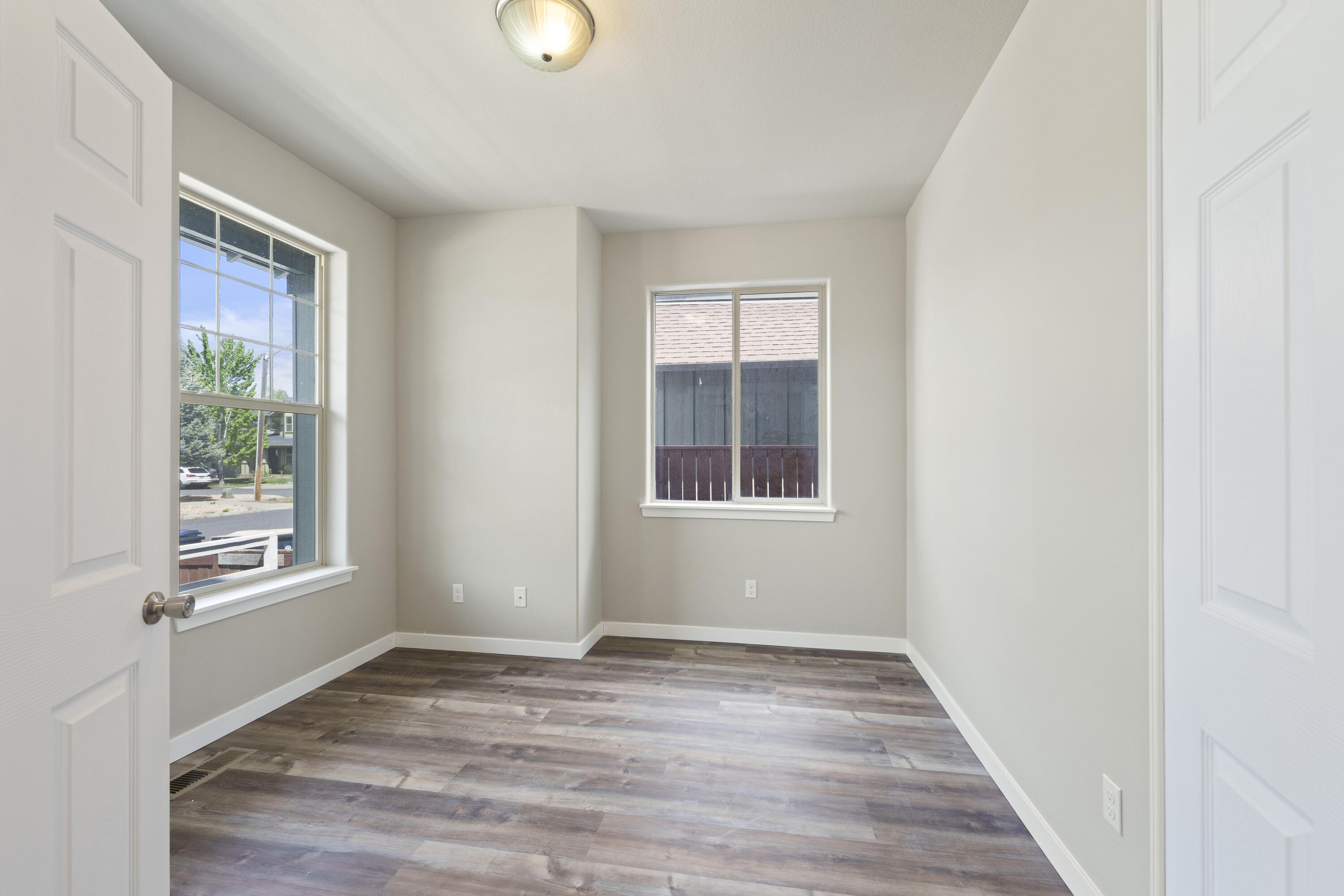 21189 Ritz Place Bend, OR 97702 - Photo 10 of 37 a view of an empty room with wooden floor and a window
