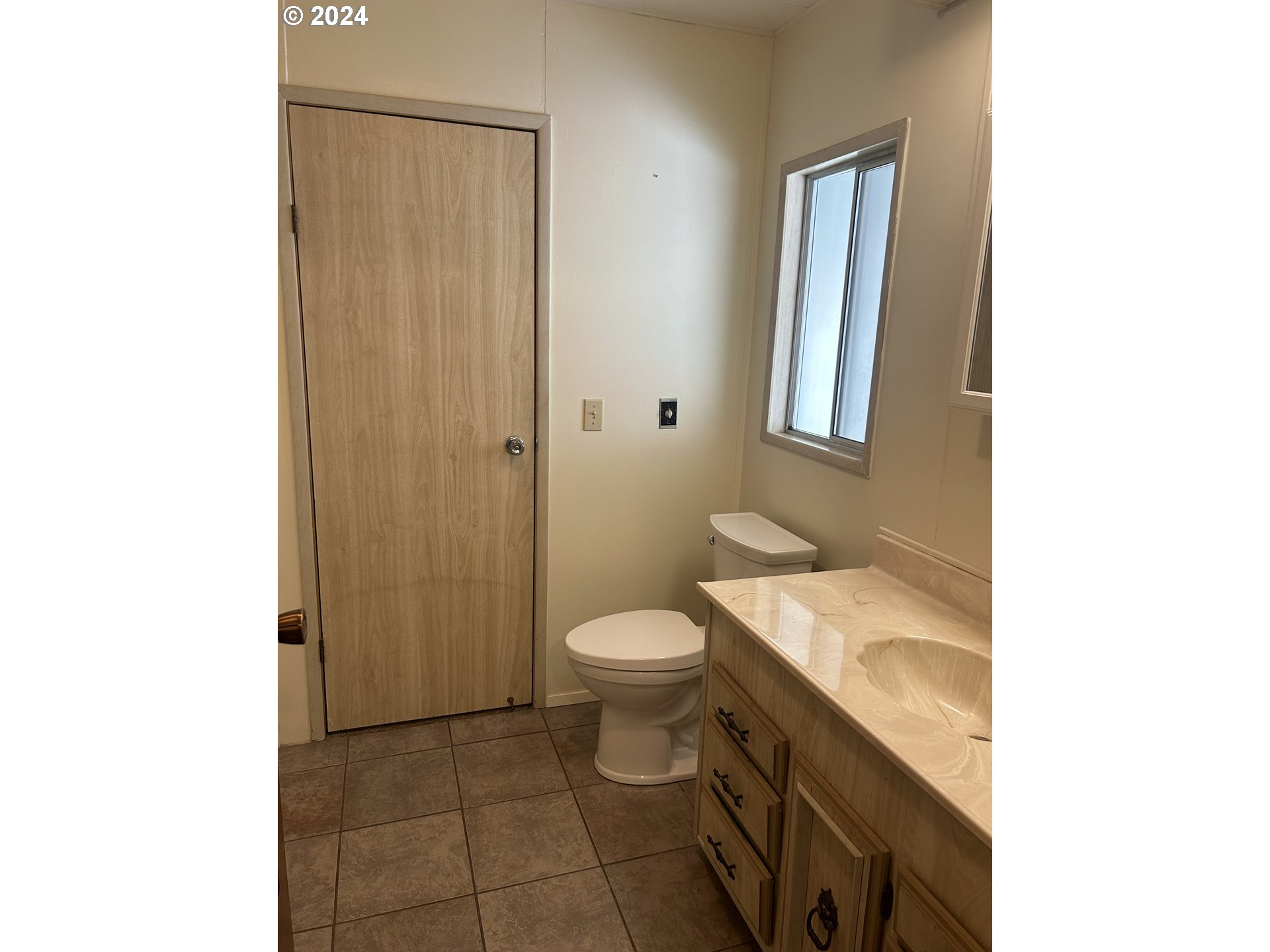4800 Barger Drive Eugene, OR 97402 - Photo 16 of 20 a bathroom with a granite countertop toilet and a sink