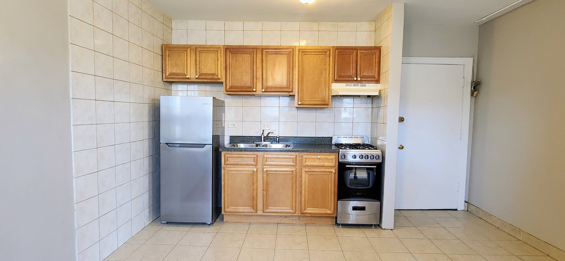 4764 North Virginia Avenue, Unit 206 Chicago, IL 60625 - Photo 4 of 16 a kitchen with stainless steel appliances granite countertop a refrigerator and a stove