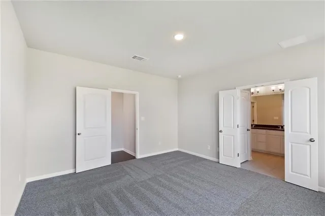 a bathroom with a double vanity sink and mirror with bathtub