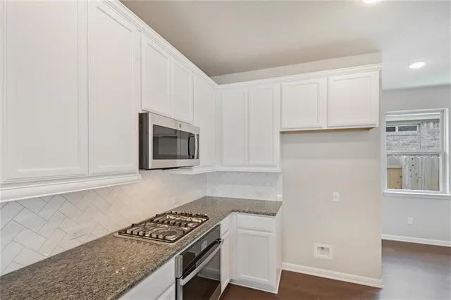 a view of a kitchen counter top space a sink wooden floor and center island