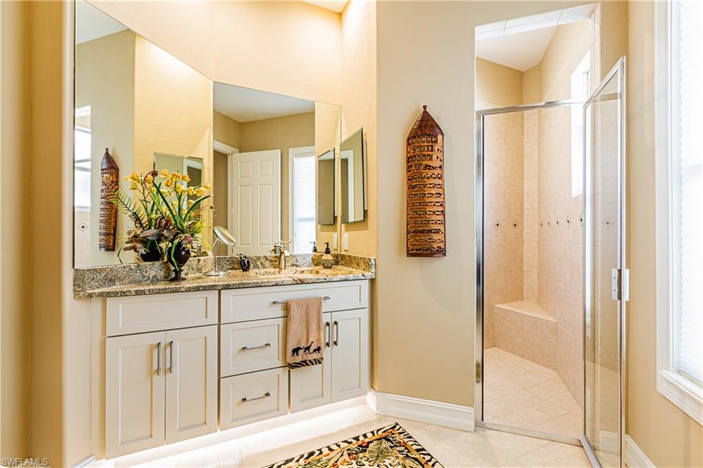 20196 Markward Crossing Estero, FL 33928 - Photo 11 of 28 a bathroom with a granite countertop sink and a mirror