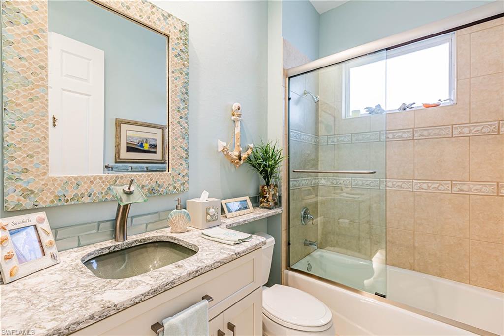 20196 Markward Crossing Estero, FL 33928 - Photo 13 of 28 a bathroom with a granite countertop sink toilet and shower
