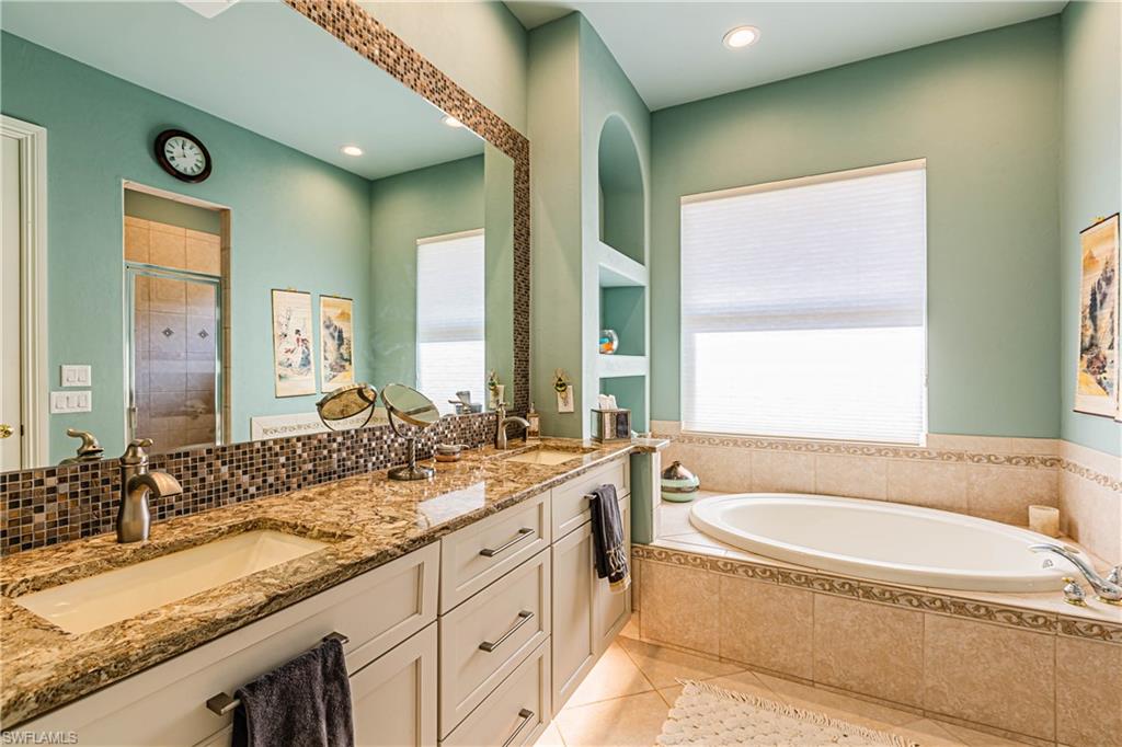 20196 Markward Crossing Estero, FL 33928 - Photo 8 of 28 a bathroom with a granite countertop tub sink and mirror