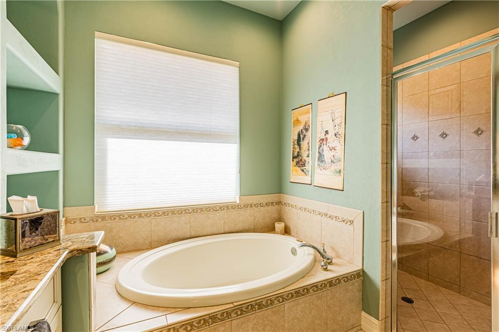 20196 Markward Crossing Estero, FL 33928 - Photo 9 of 28 a bathroom with a sink and a bathtub