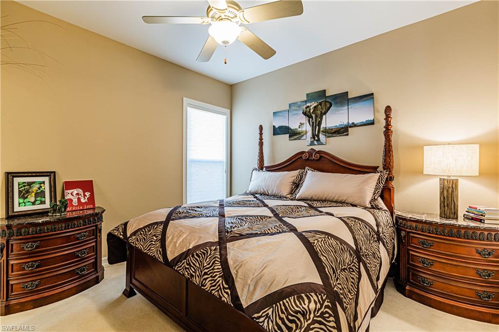 20196 Markward Crossing Estero, FL 33928 - Photo 10 of 28 a bedroom with a bed and a chandelier