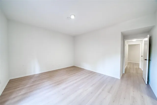 a bathroom with a granite countertop sink toilet and mirror