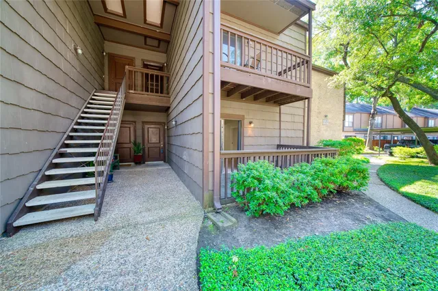 a view of a house with backyard and wooden fence