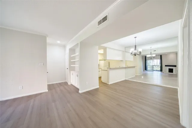 a view of wooden floor and windows in a room