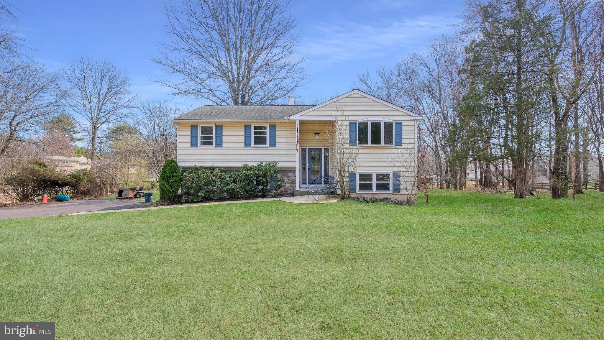 a front view of a house with a garden and yard