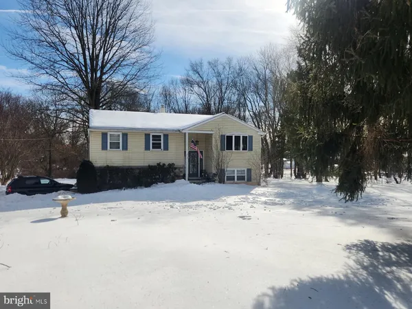 a view of a house with snow on the road