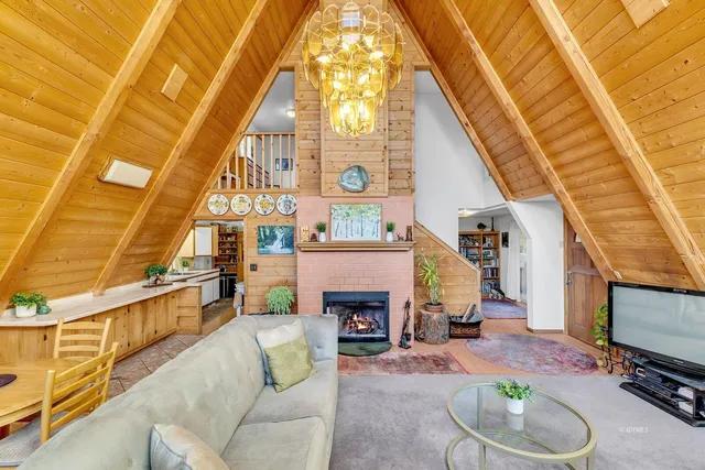 a living room with fireplace furniture and a wooden floor