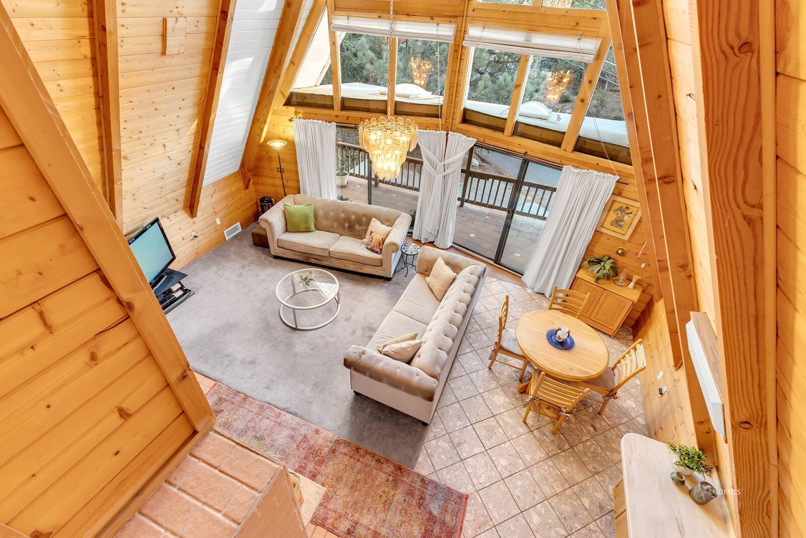 26750 Saunders Meadow Road, Unit 775 Idyllwild, CA 92549 - Photo 16 of 68 a living room with furniture and a floor to ceiling window