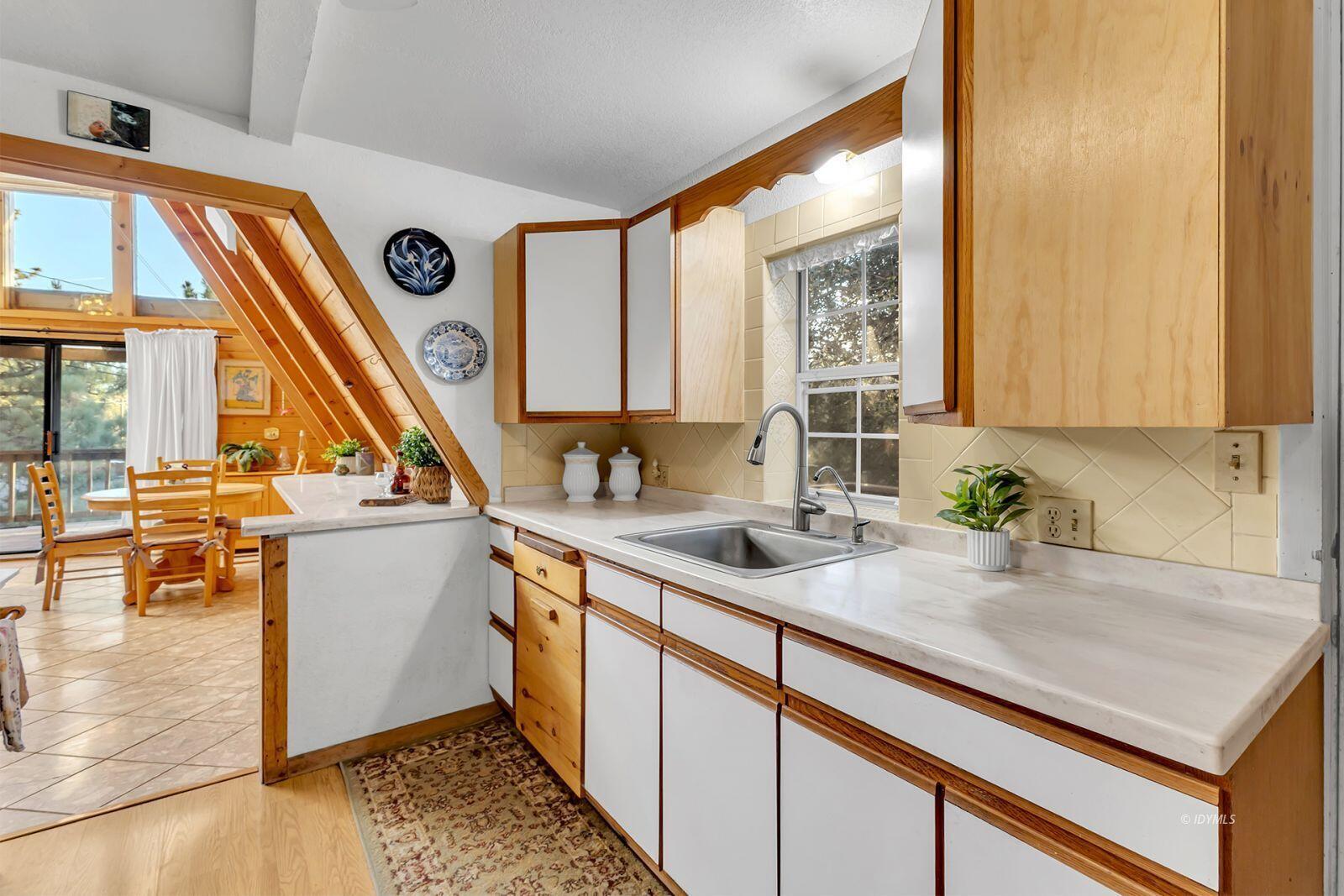 26750 Saunders Meadow Road, Unit 775 Idyllwild, CA 92549 - Photo 17 of 68 a kitchen with a sink a counter top space and cabinets