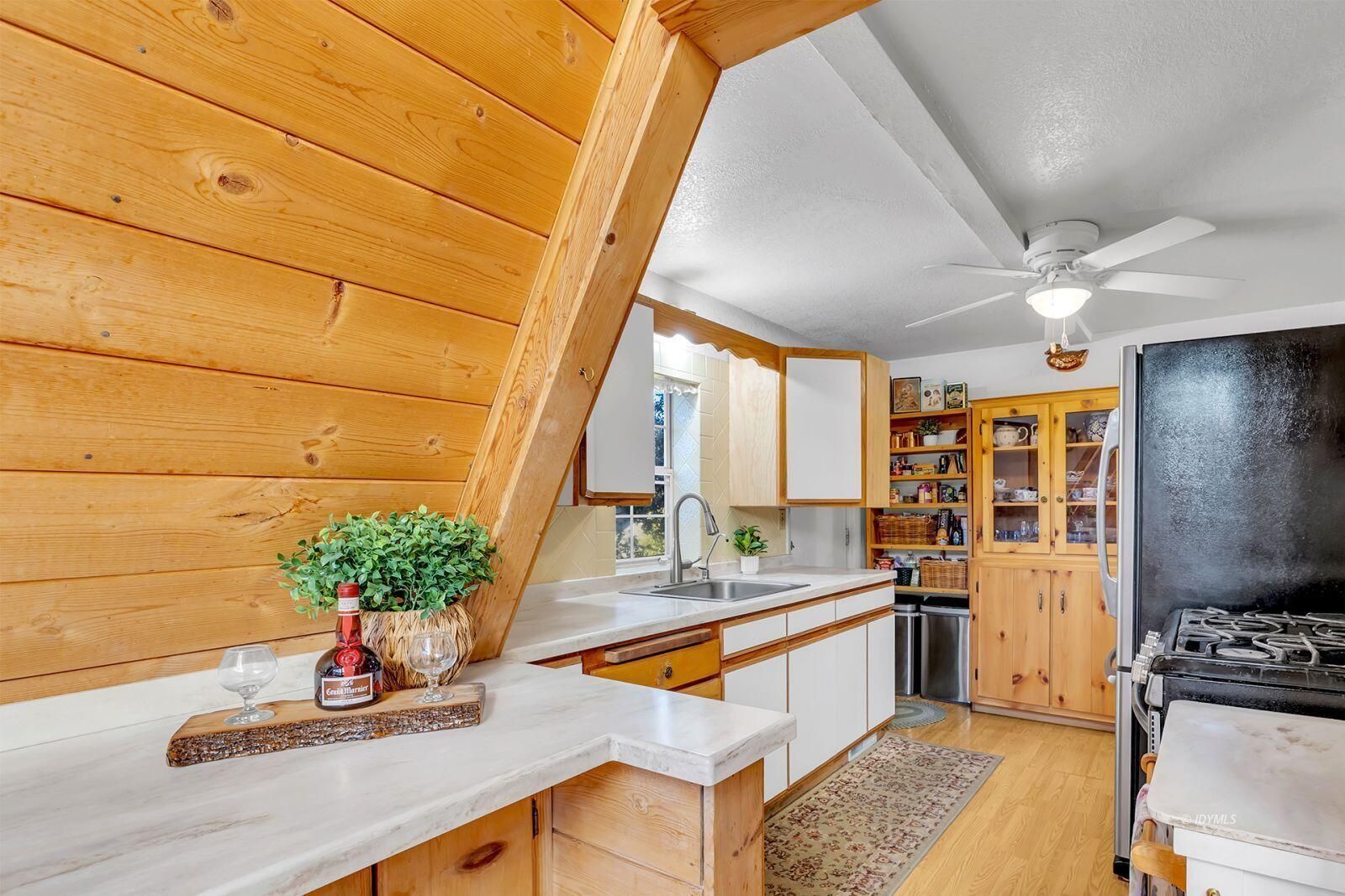 26750 Saunders Meadow Road, Unit 775 Idyllwild, CA 92549 - Photo 19 of 68 a kitchen with stainless steel appliances granite countertop a sink a stove and a wooden floor