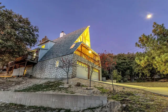 a backyard of a house with a yard and outdoor seating