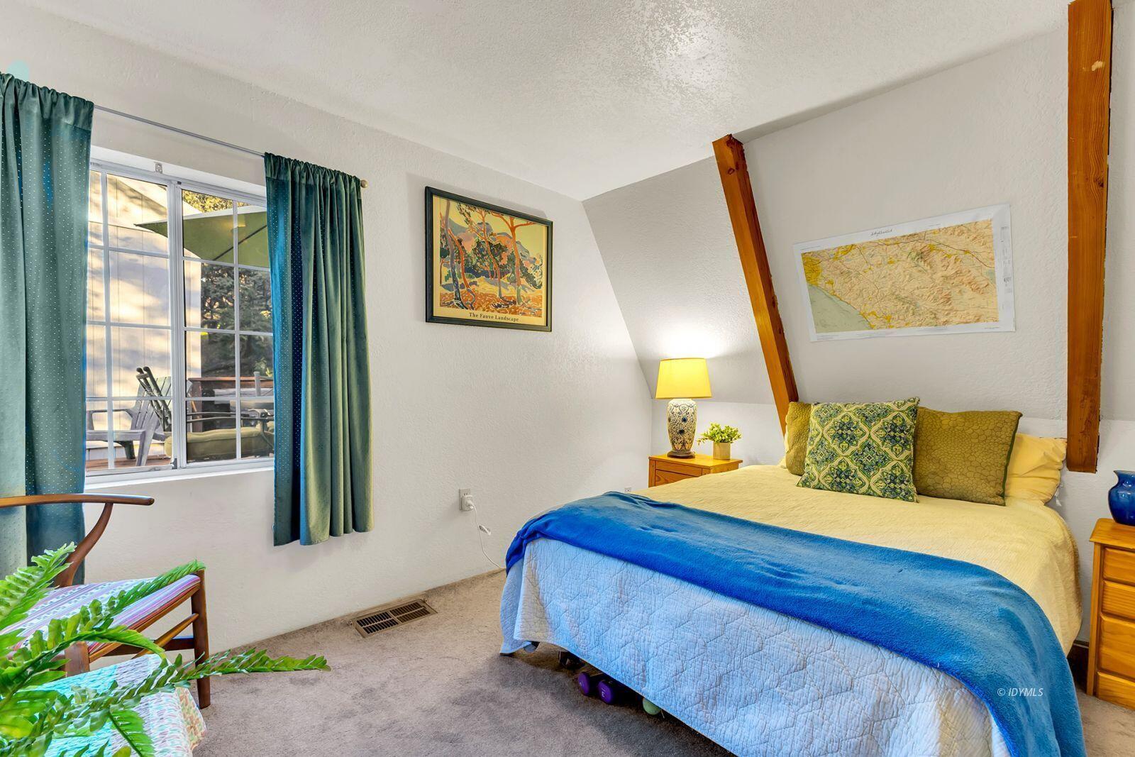 26750 Saunders Meadow Road, Unit 775 Idyllwild, CA 92549 - Photo 24 of 68 a bedroom with a bed and a painting on the wall