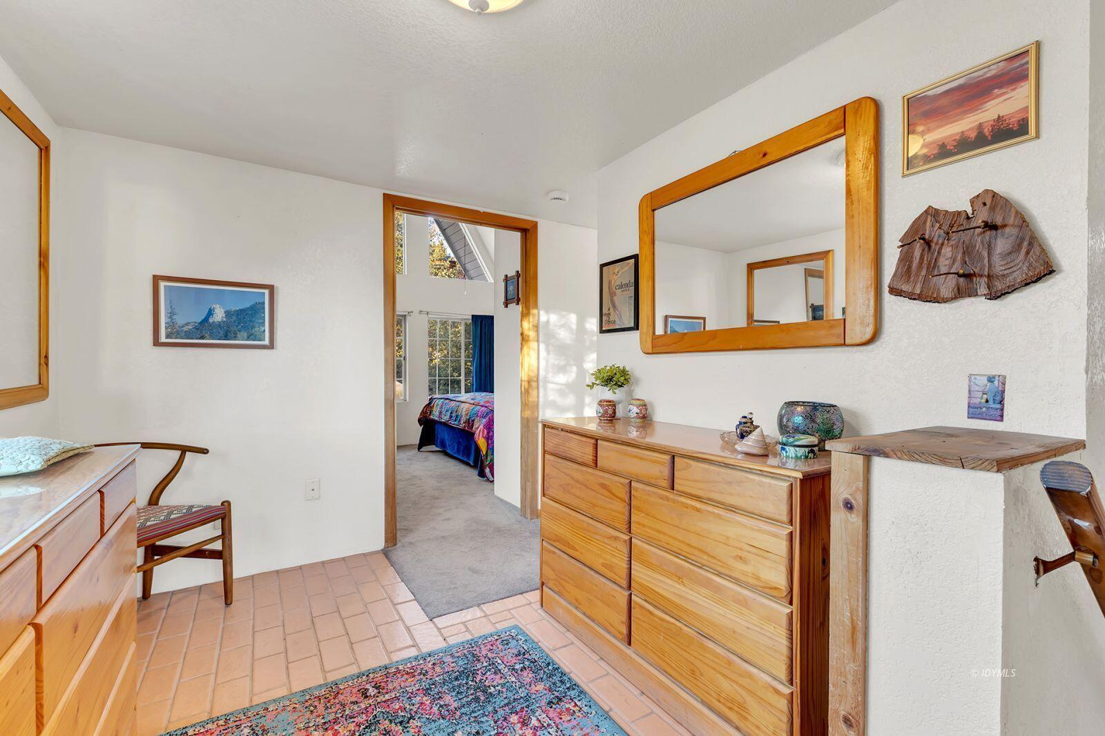 26750 Saunders Meadow Road, Unit 775 Idyllwild, CA 92549 - Photo 30 of 68 a bedroom with a bed and furniture