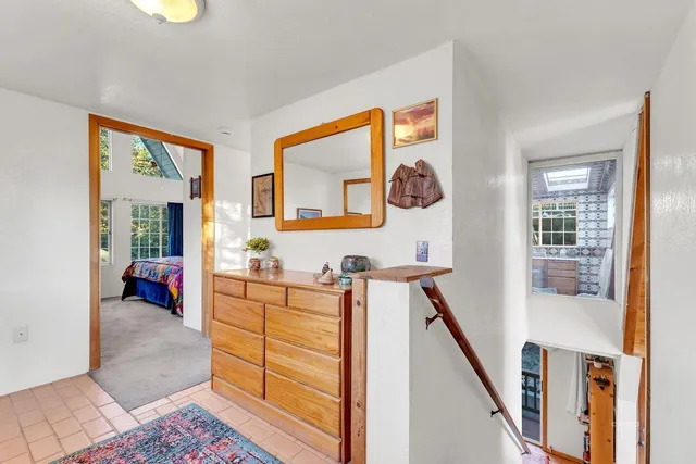 a backyard of a house with wooden floor and outdoor seating