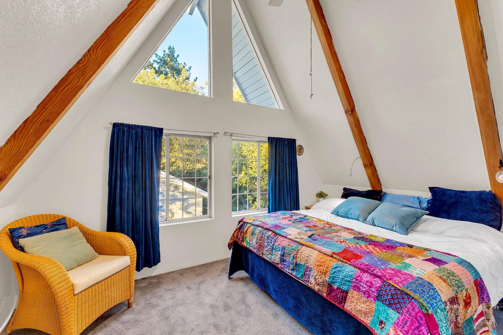 26750 Saunders Meadow Road, Unit 775 Idyllwild, CA 92549 - Photo 34 of 68 a bedroom with a bed and a couch