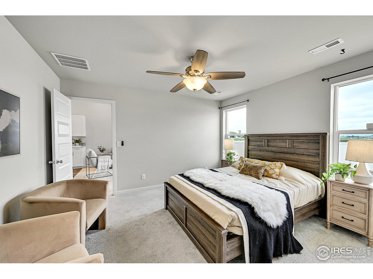 403 Pony Express Trail Ault, CO 80610 - Photo 14 of 31 a bedroom with a bed and a chandelier