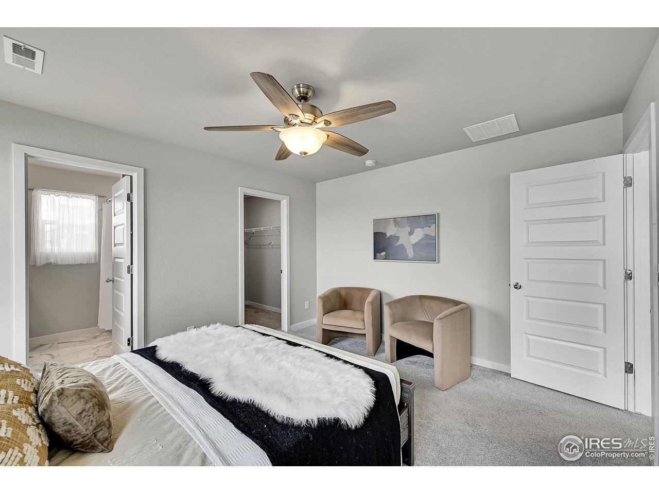403 Pony Express Trail Ault, CO 80610 - Photo 15 of 31 a bedroom with a bed and a chandelier