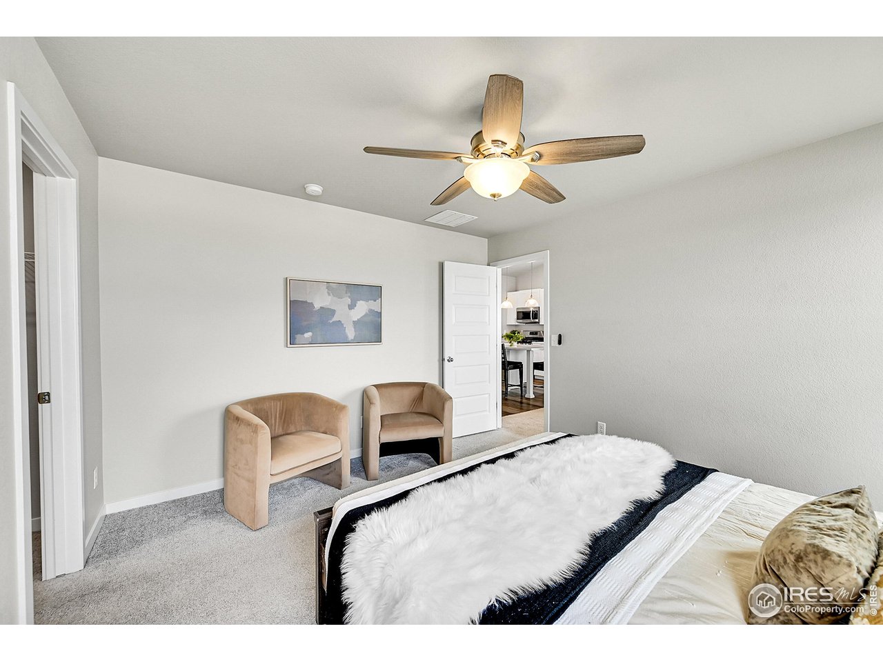 403 Pony Express Trail Ault, CO 80610 - Photo 16 of 31 a bedroom with a bed and ceiling fan